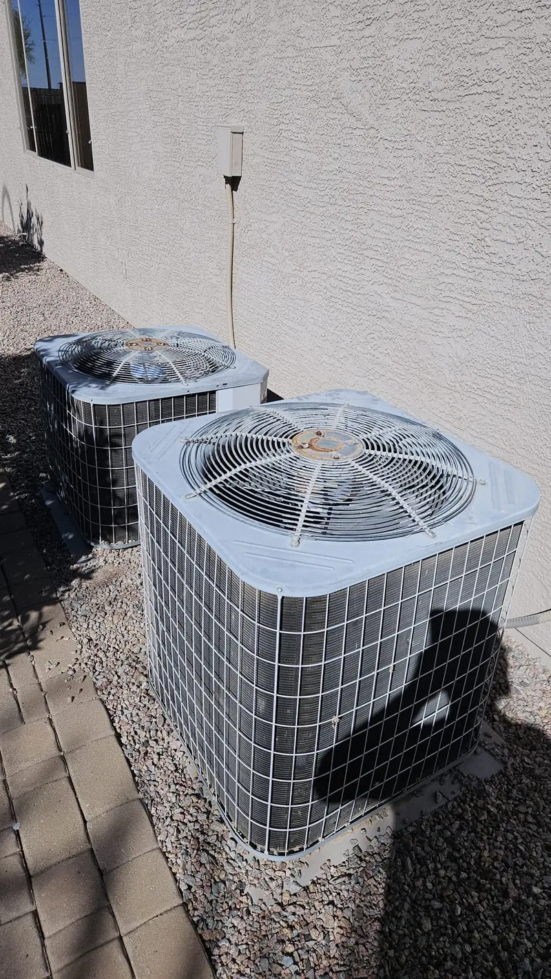 Two outdoor AC units beside an Arizona home