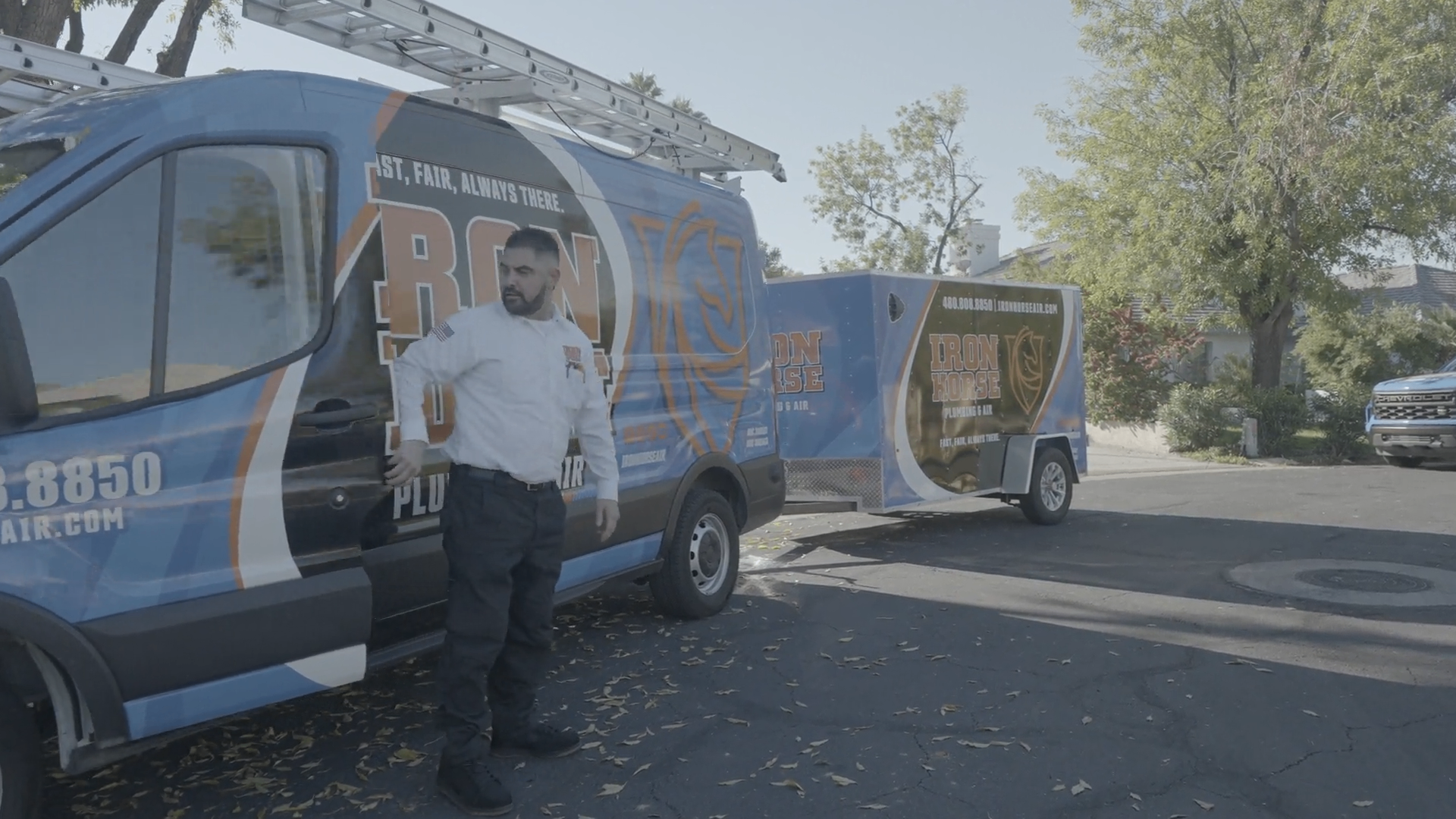 Iron Horse Plumbing & Air service van and trailer on a Phoenix Metro neighborhood street