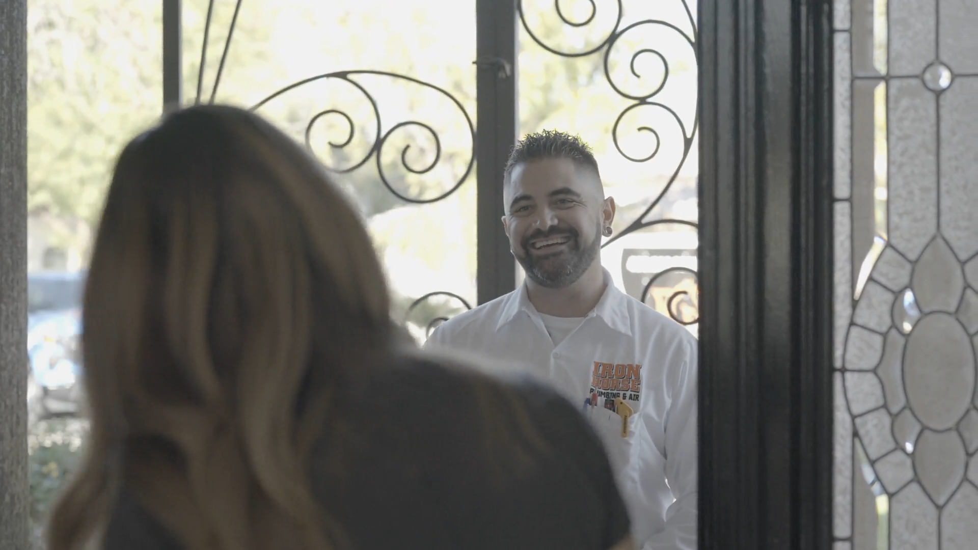 Iron Horse technician greeting a homeowner at the door